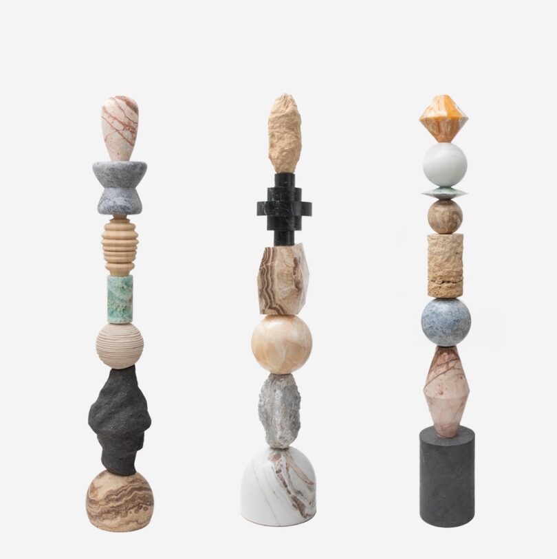 three natural stone totems on a white background